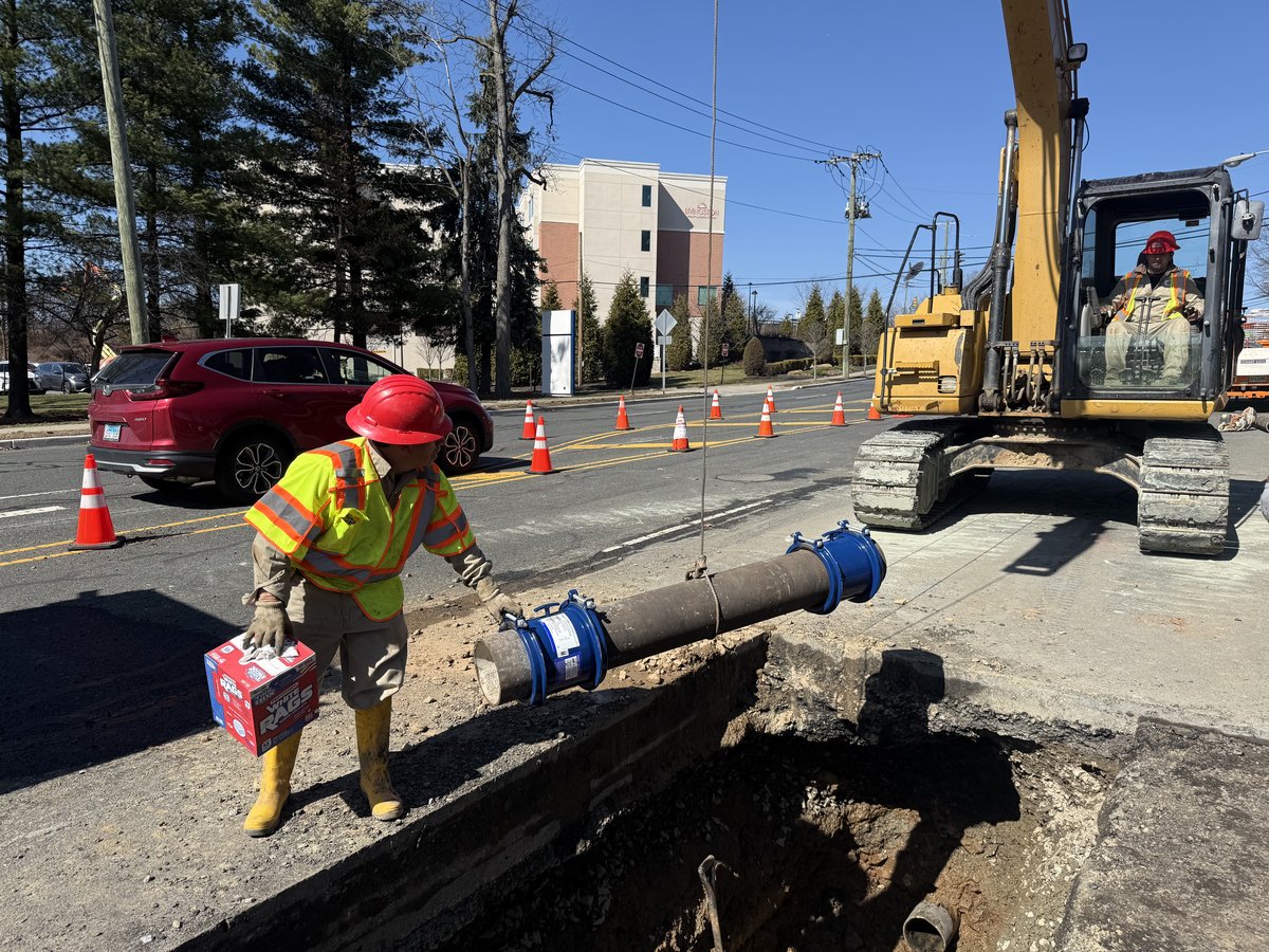 Water main repair with valves exposed on a residential street.