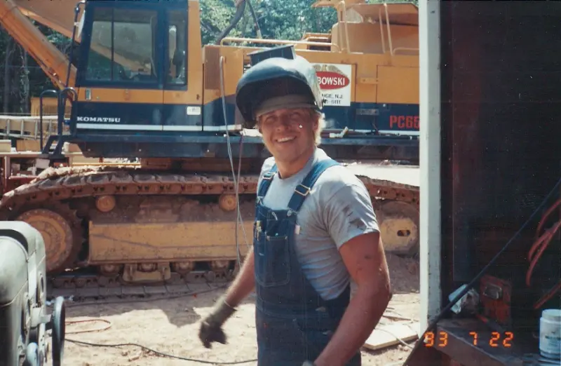 A young Grabowski operator on the yard with a Komatsu excavator behind, dated March 1993.