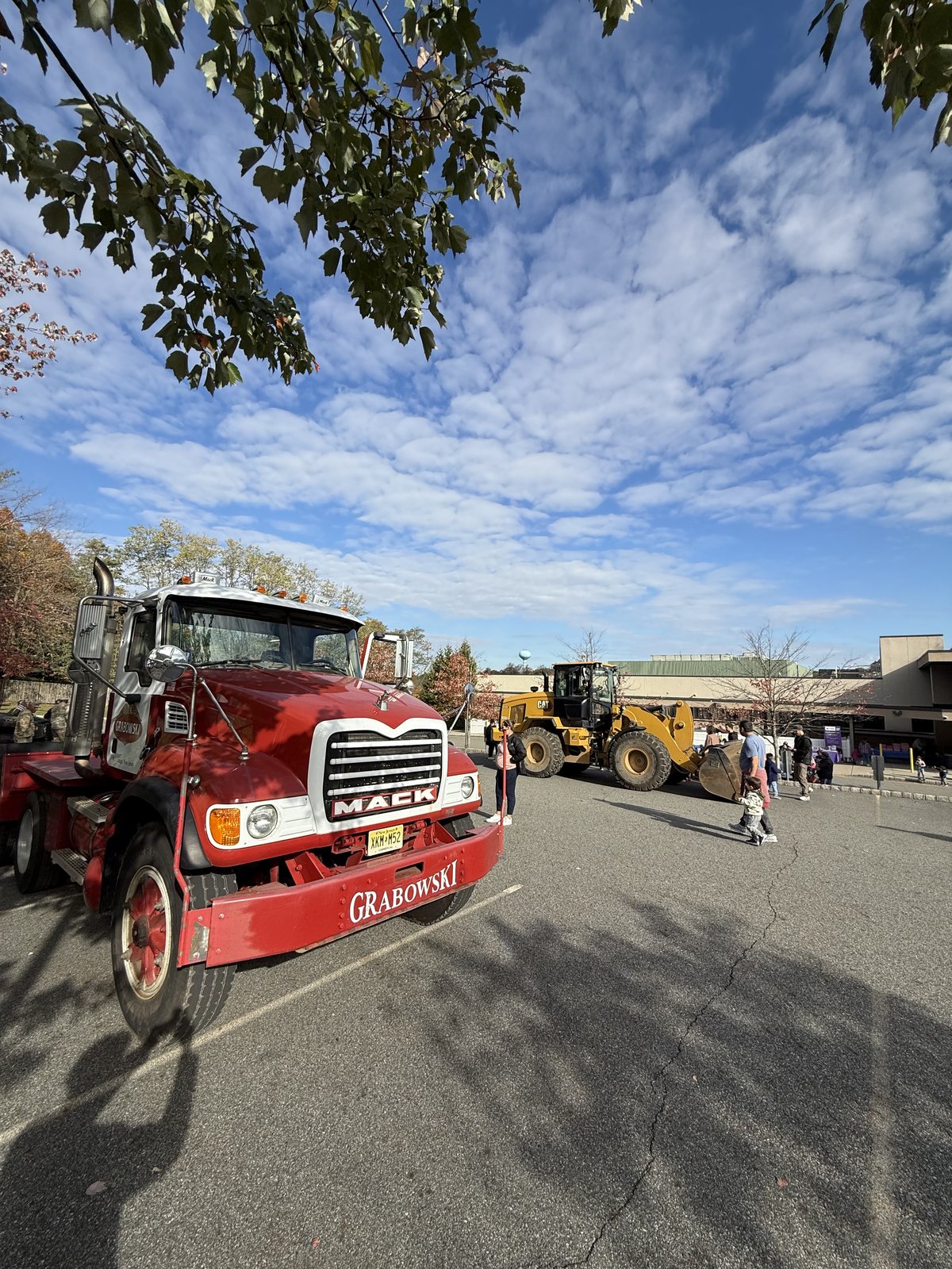 Mack truck and CAT loader staged at the touch-a-truck event lot.