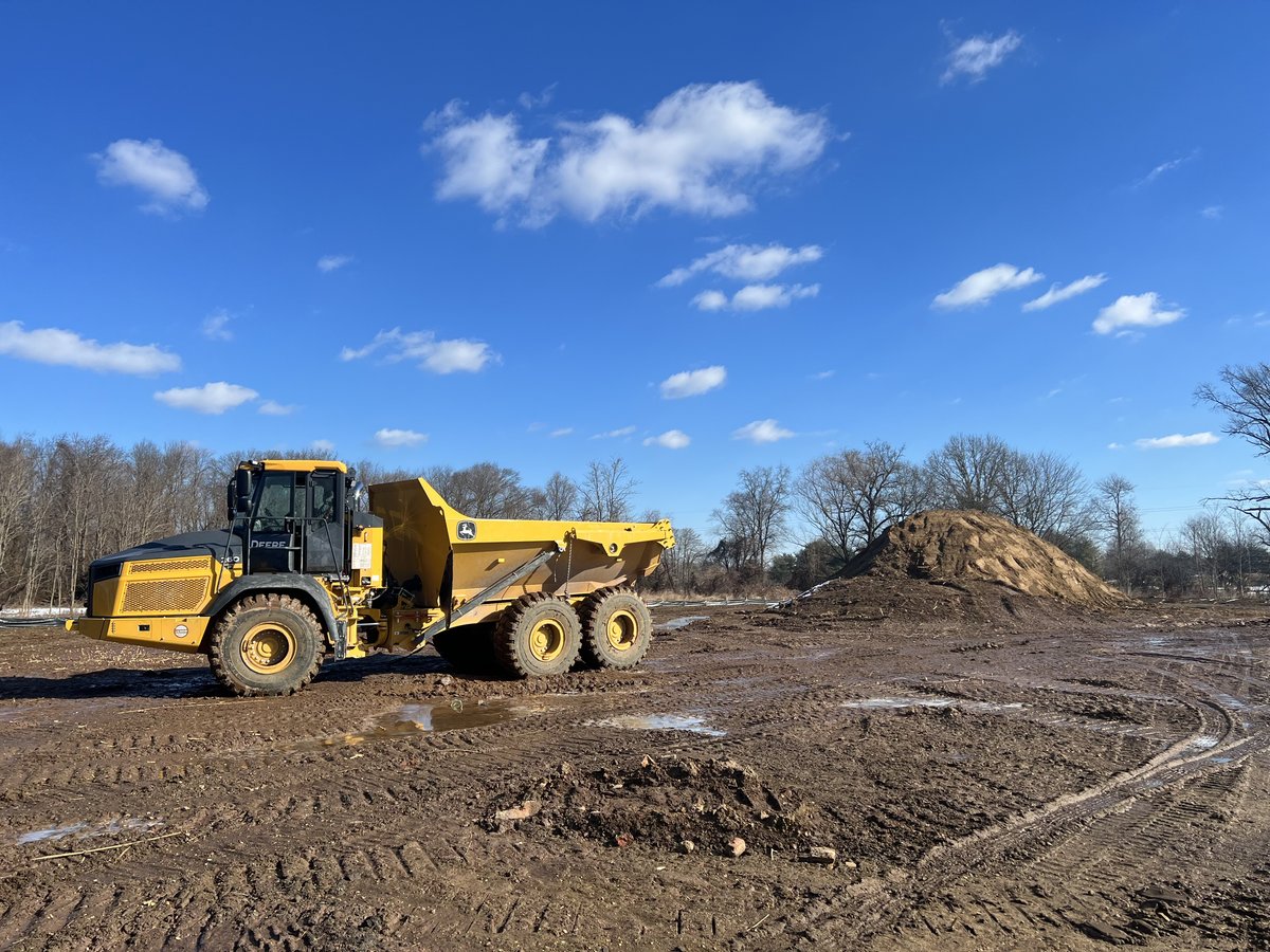 John Deere articulated dump on the graded pad at Express Auto Spa.